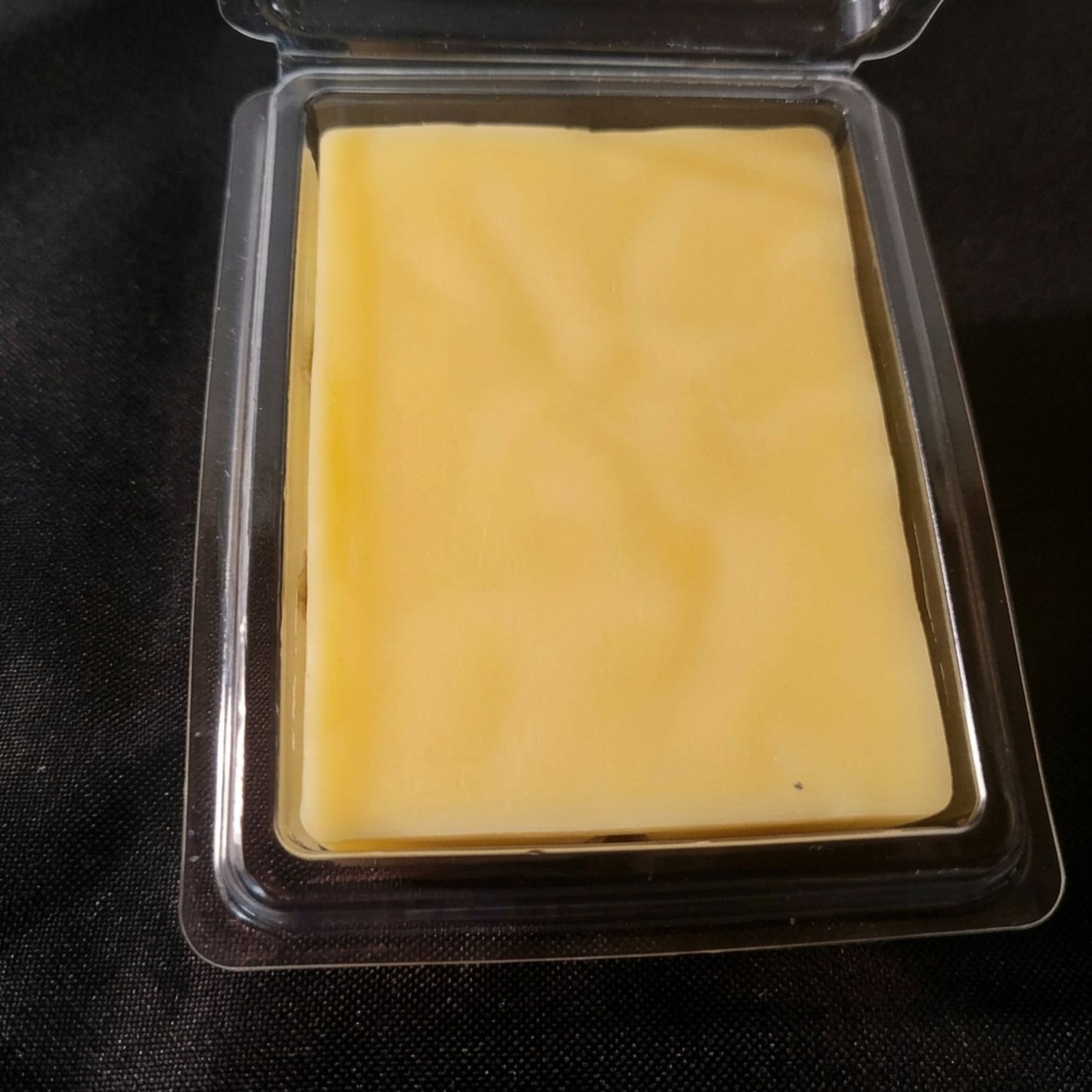 A open package of watermelon scented beeswax melts from sticky bee apiary.