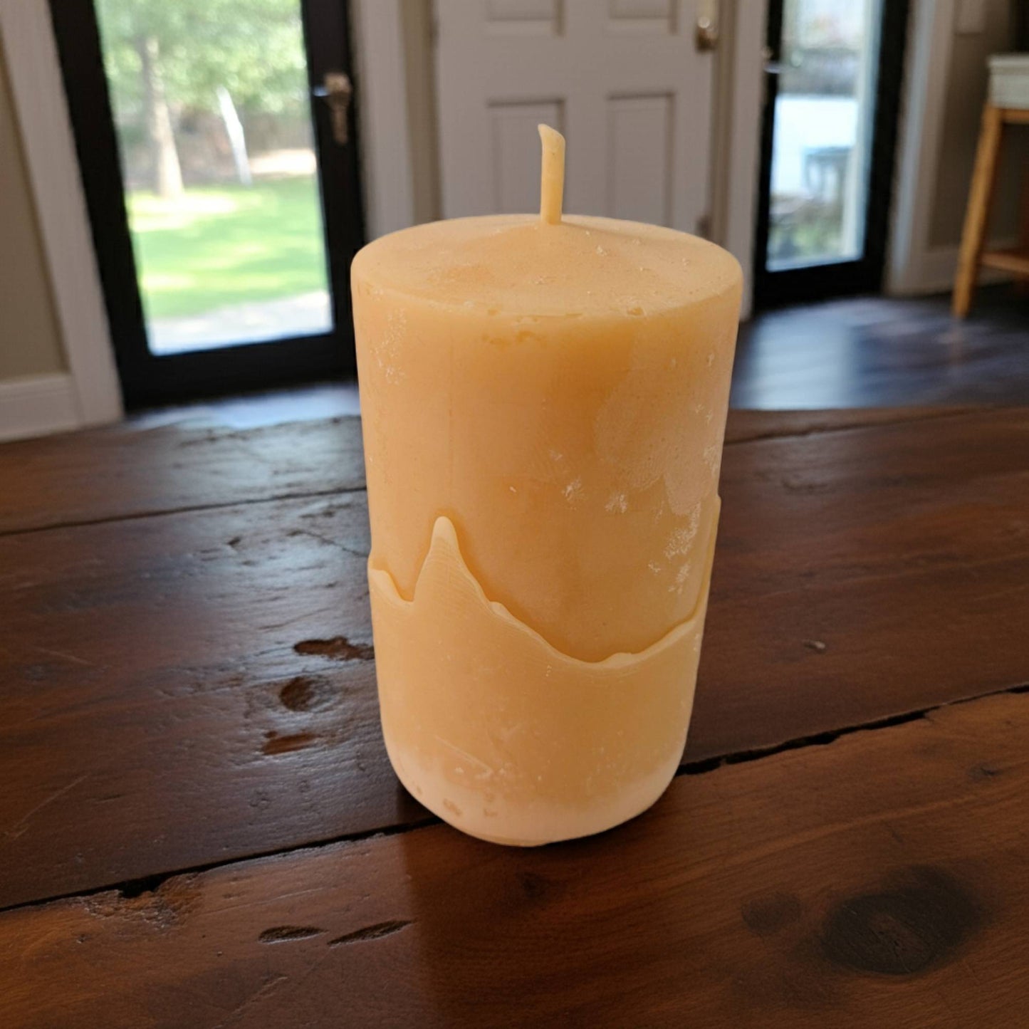 beeswax candle on a wooden surface with a blurred background