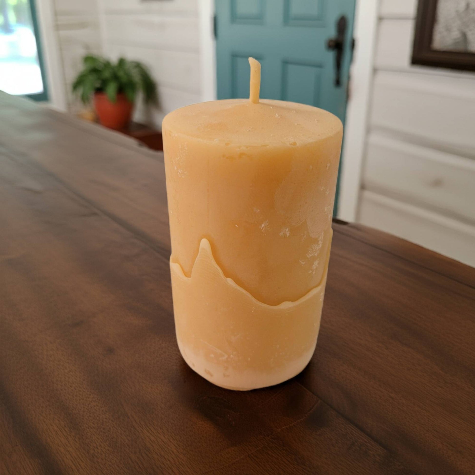 beeswax candle on a wooden table with a blurred background