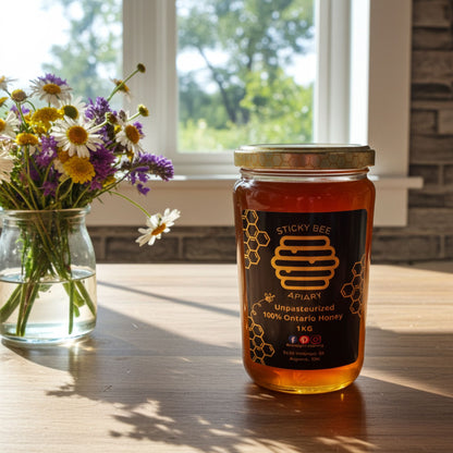 Jar of honey from Sticky Bee Apiary on a wooden table with flowers in the background