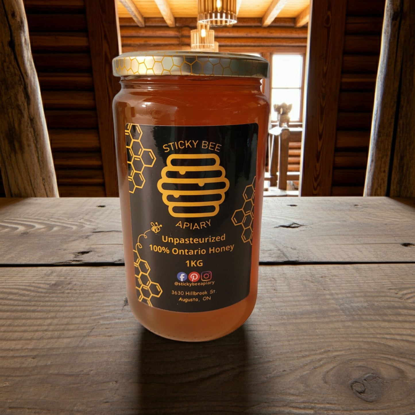 Jar of honey from Sticky Bee Apiary on a wooden surface with a rustic background