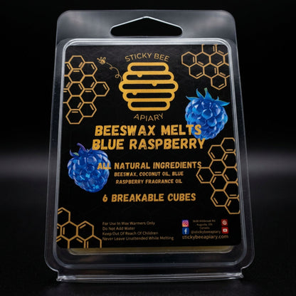 Packaging of Sticky Bee Apiary Beeswax Melts in Blue Raspberry flavor on a dark background.