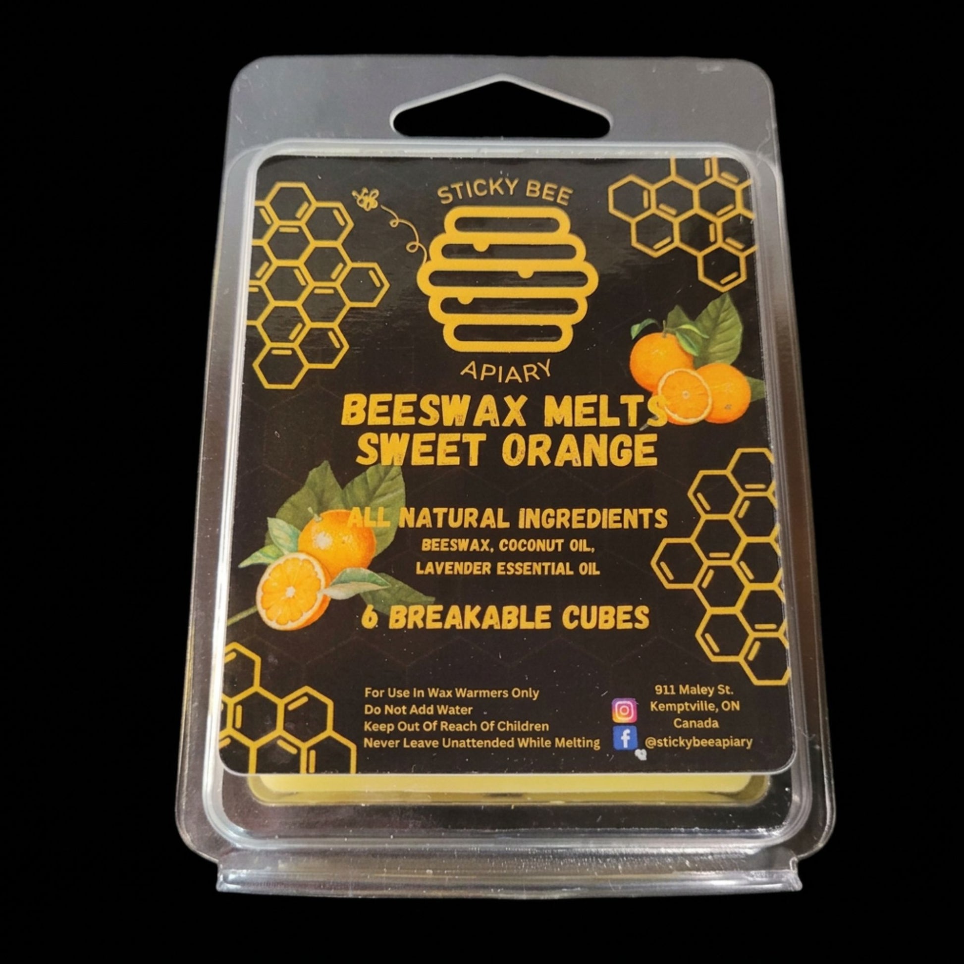Packaged beeswax melts with sweet orange scent 'Sticky Bee Apiary' branding on a black background