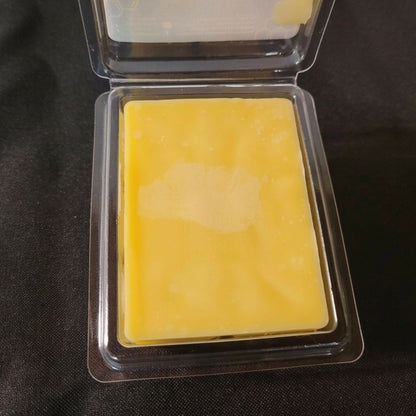 An open package of pure beeswax sweet orange scented wax melt from sticky bee apiary.