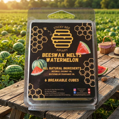 Beeswax melts packaging with watermelon scent on a wooden surface with watermelons in the background.